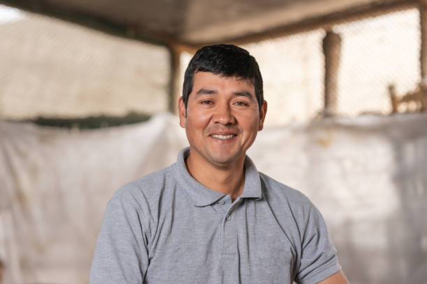 Portrait of a smiling farmer in a guinea pig farm